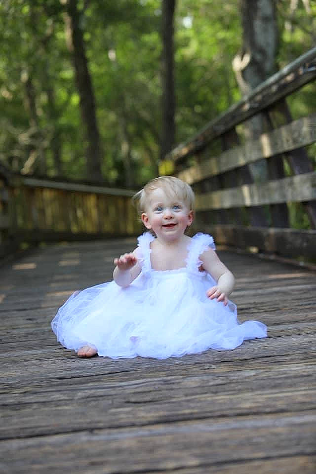 Mela is registered to the contest to win money with this photo: baby_toddler_clothing, bridal_accessory, bridal_clothing, bridal_party_dress, dress, flash_photography, forest, formal_wear, fun, gown, grass, happy, joy, leisure, people_in_nature, person, plant, recreation, smile, toddler