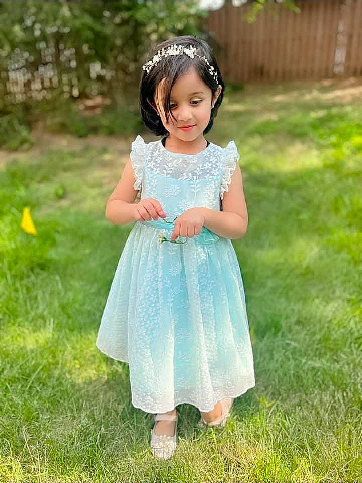 Aashvee joined the competition — help win amazing prizes! baby_toddler_clothing, child, clothing, day_dress, dress, face, grass, grassland, hair, happy, head, meadow, one_piece_garment, pattern, people_in_nature, person, plant, sleeve, smile, toddler