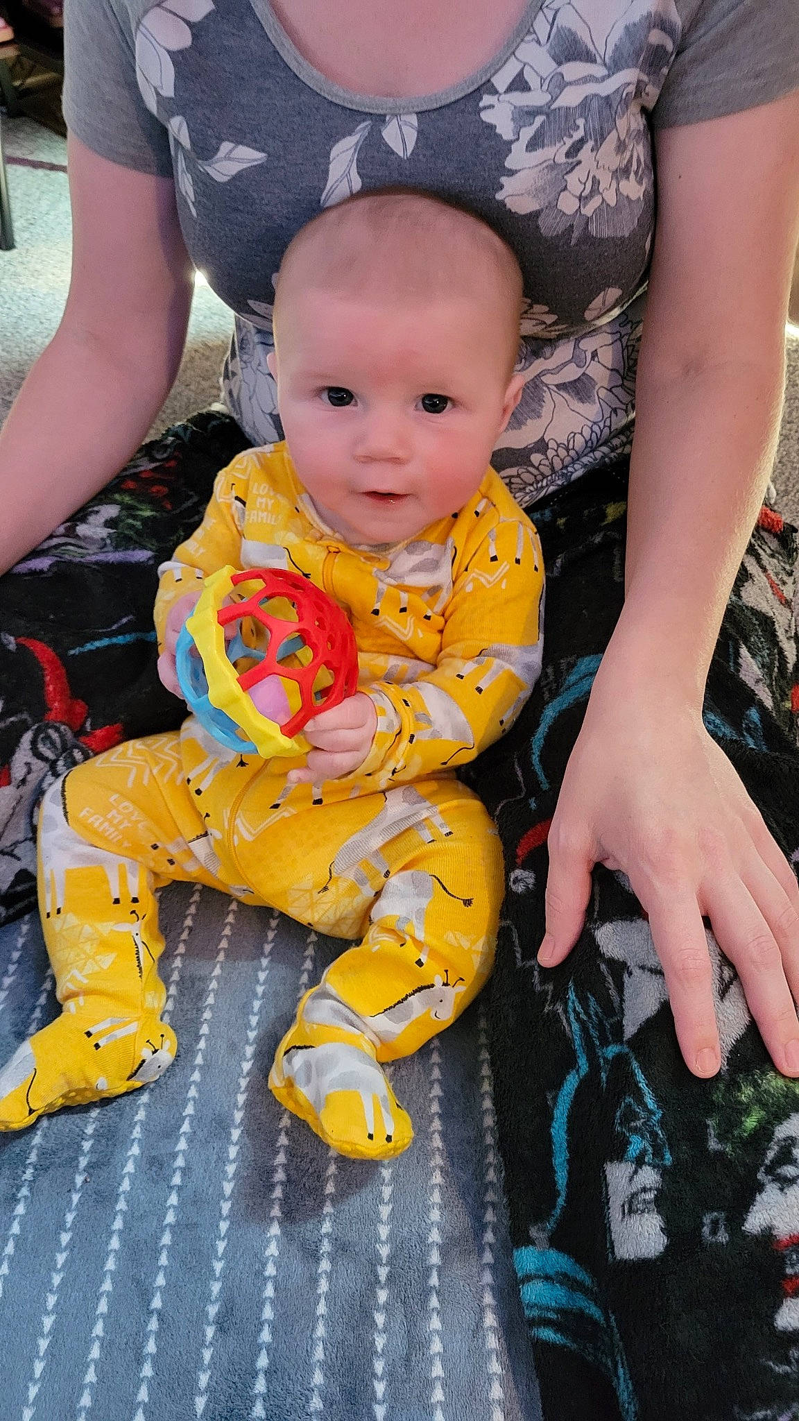 George joined the competition — help win amazing prizes! baby, baby_products, baby_toddler_clothing, child, event, face, flooring, fun, happy, head, human_body, human_leg, lap, orange, pattern, people, person, sitting, thigh, toddler