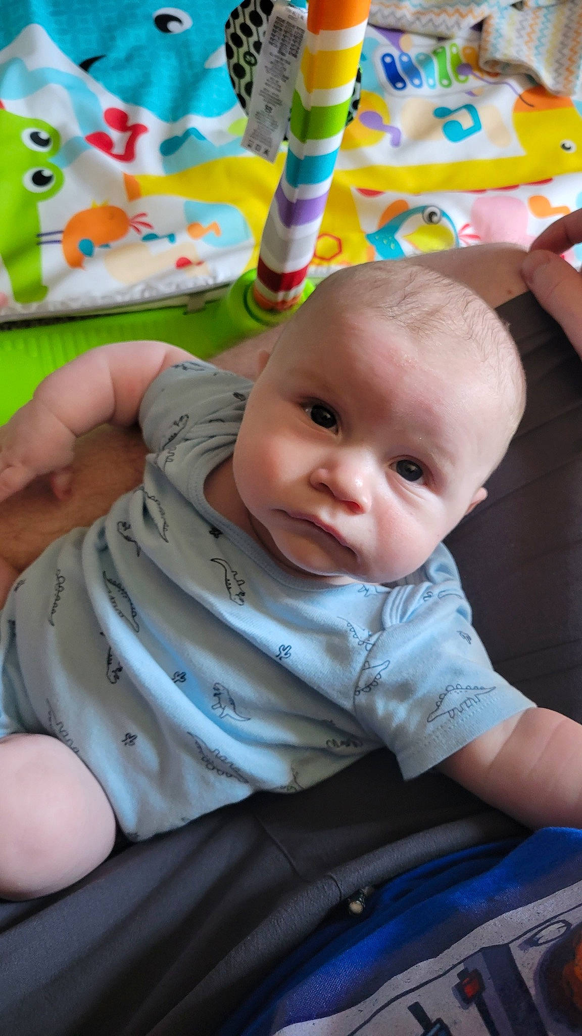 George is registered to the contest to win money with this photo: baby, baby_toddler_clothing, blue, cheek, child, chin, comfort, eye, facial_expression, fun, happy, head, iris, person, product, skin, sleeve, textile, toddler, white