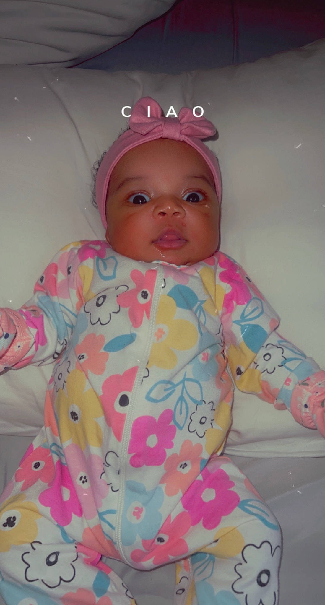 Kimora is registered to the contest to win money with this photo: baby, baby_products, baby_toddler_clothing, cheek, child, comfort, face, fashion_accessory, fun, happy, headwear, linens, magenta, pattern, person, pink, play, sitting, skin, sleeve