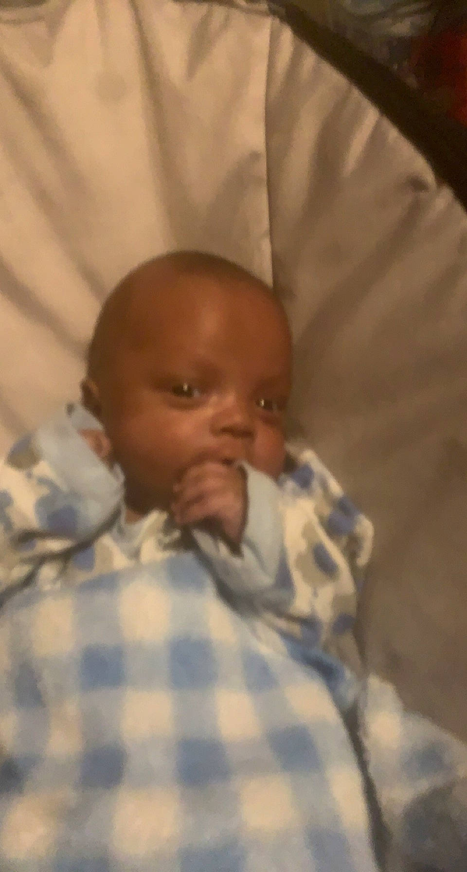 Keshawn joined the competition — help win amazing prizes! baby, baby_products, bed, bedding, bedtime, cheek, child, chin, comfort, eyebrow, head, iris, linens, mouth, nose, pattern, person, plaid, room, tartan