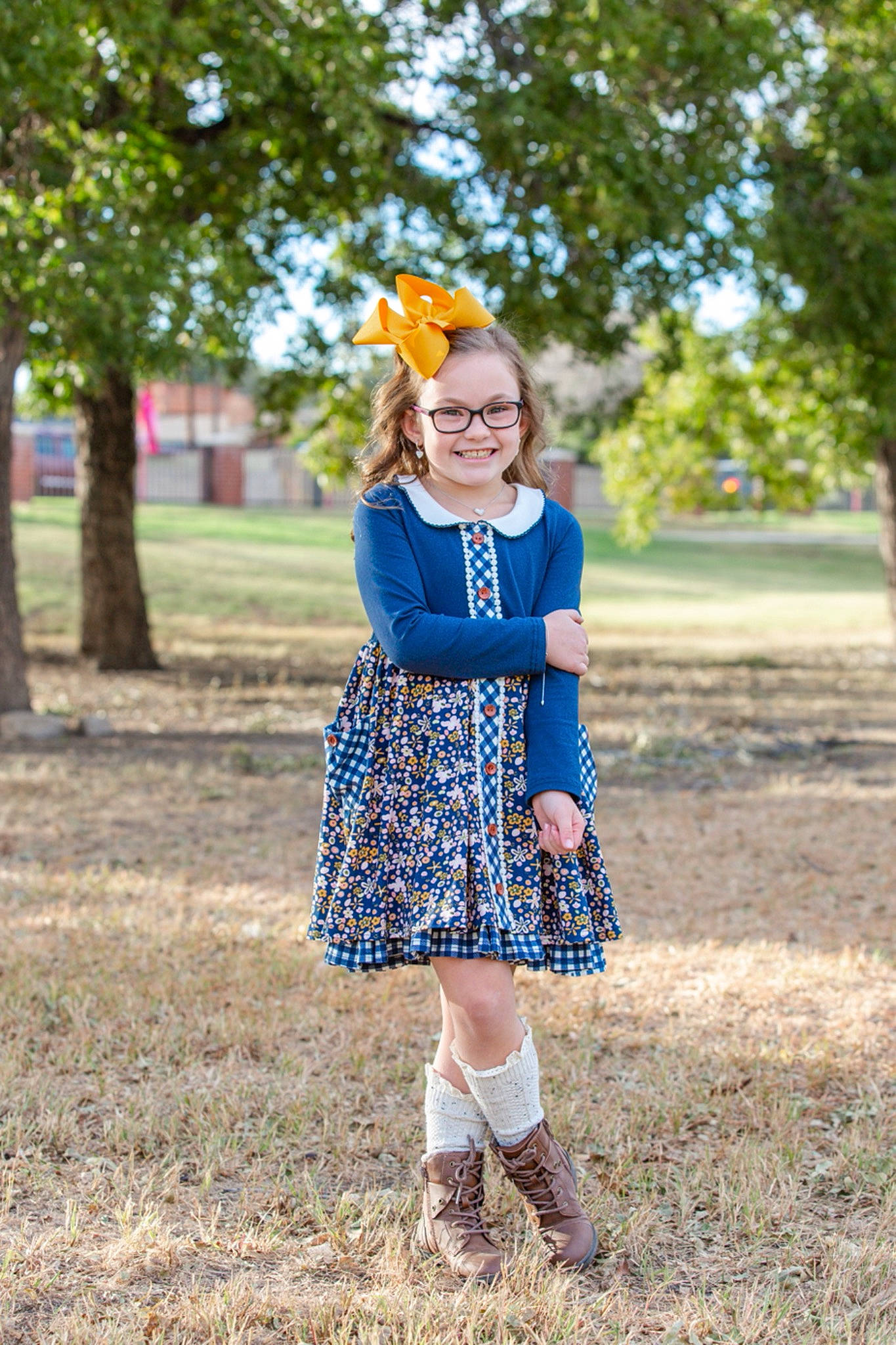 Hallie is registered to the contest to win money with this photo: day_dress, denim, dress, electric_blue, grass, grassland, happy, joy, knee, outerwear, people_in_nature, person, plaid, shoe, sleeve, smile, street_fashion, sunlight, tartan, toddler