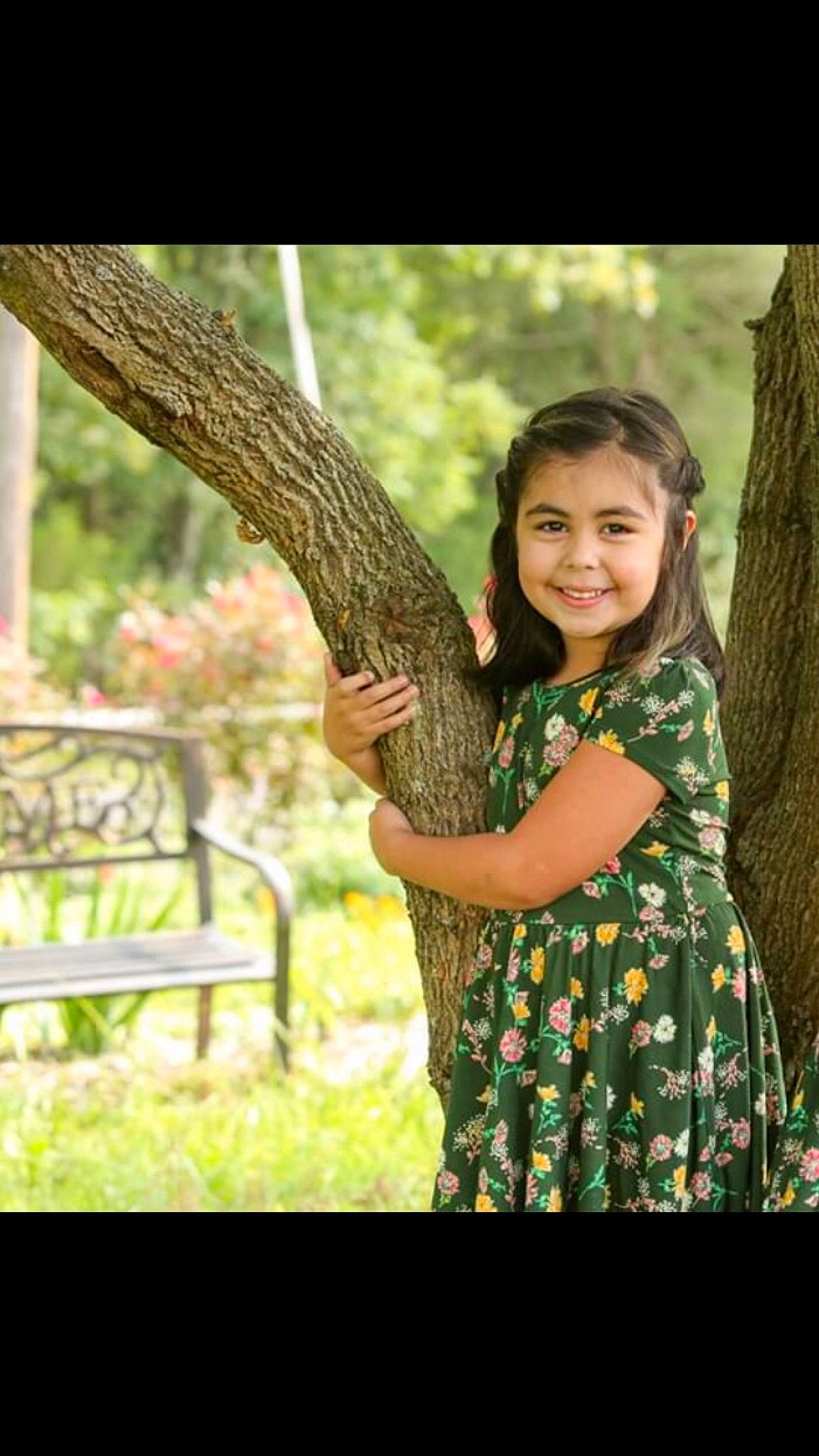 Evelyn joined the competition — help win amazing prizes! bench, child_model, day_dress, happy, joy, long_hair, one_piece_garment, outdoor_bench, outdoor_furniture, park, pattern, people_in_nature, person, photo_shoot, portrait_photography, spring, street_furniture, trunk