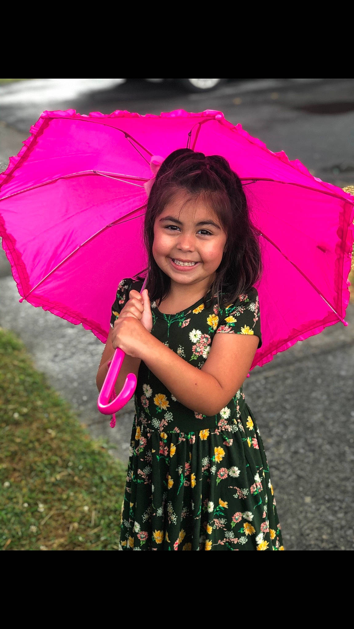 Evelyn is registered to the contest to win money with this photo: baby_toddler_clothing, beauty, child_model, day_dress, embellishment, facial_expression, happy, joy, laugh, magenta, mouth, nose, one_piece_garment, people_in_nature, person, pink, purple, umbrella, violet