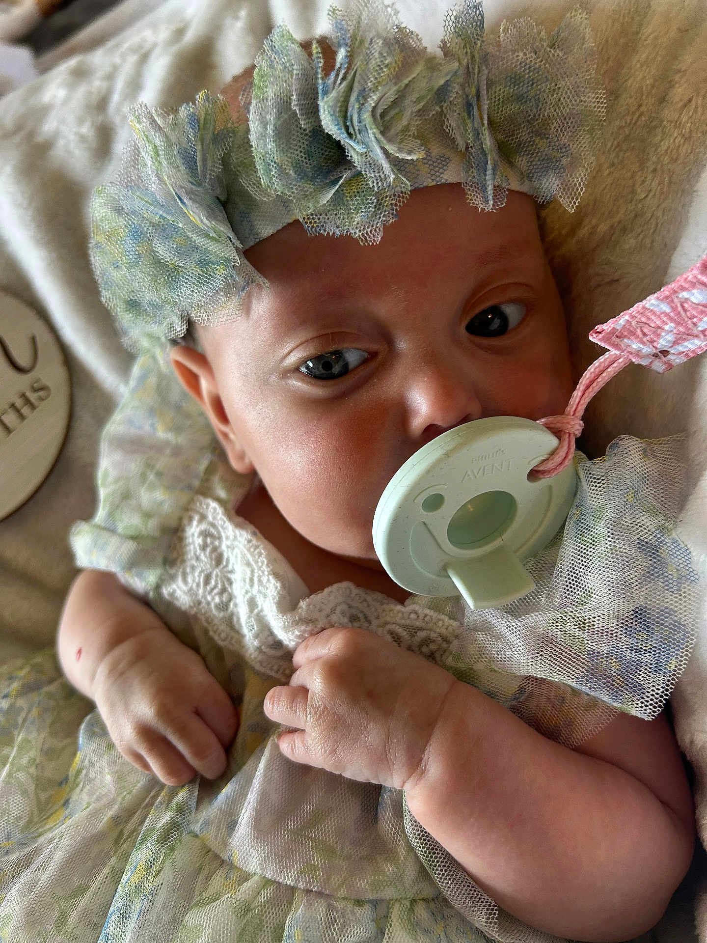 Lilah is registered to the contest to win money with this photo: baby, infant, pacifier, headband, lace, dress, hand, fist, face, skin, blanket, closeup, newborn, sleepwear, soft, cute, child, indoors, portrait, peaceful