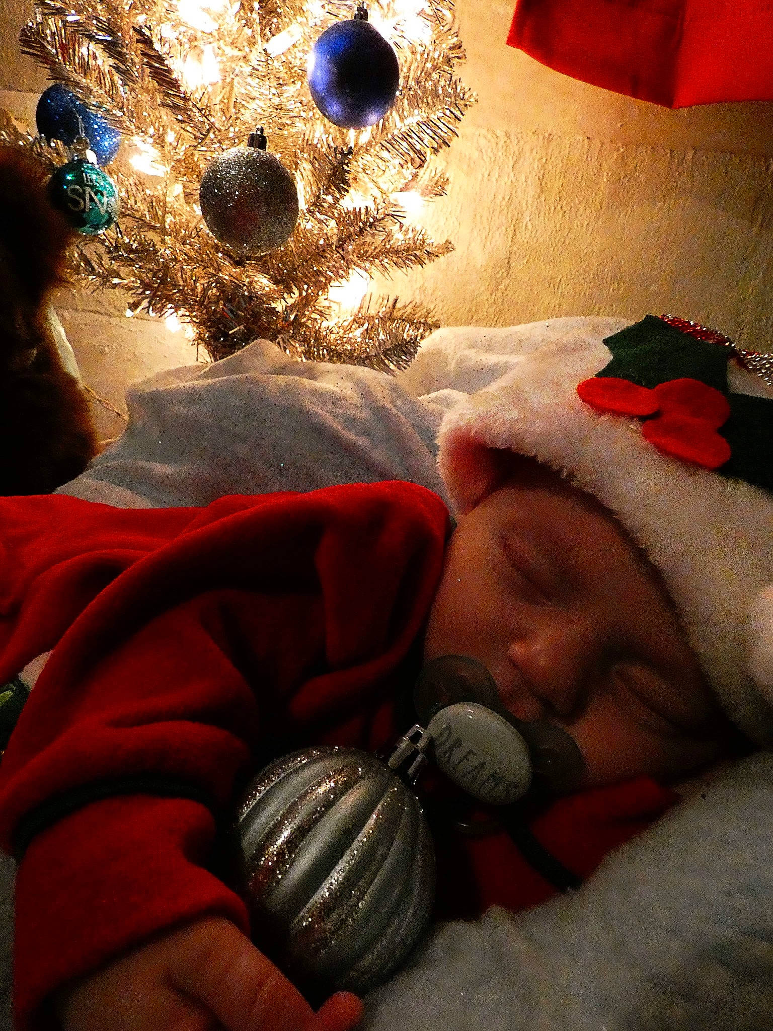 Jared joined the competition — help win amazing prizes! baby, baby_sleeping, cap, christmas, christmas_decoration, christmas_ornament, christmas_tree, comfort, event, fun, happy, headwear, holiday, holiday_ornament, light, ornament, person, red, textile, toddler