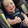 baby, car_seat, harness, smiling, child, infant, seatbelt, cute, face, cheeks, clothing, sitting, hand, safety, closeup, person, indoors, happy, young, transport