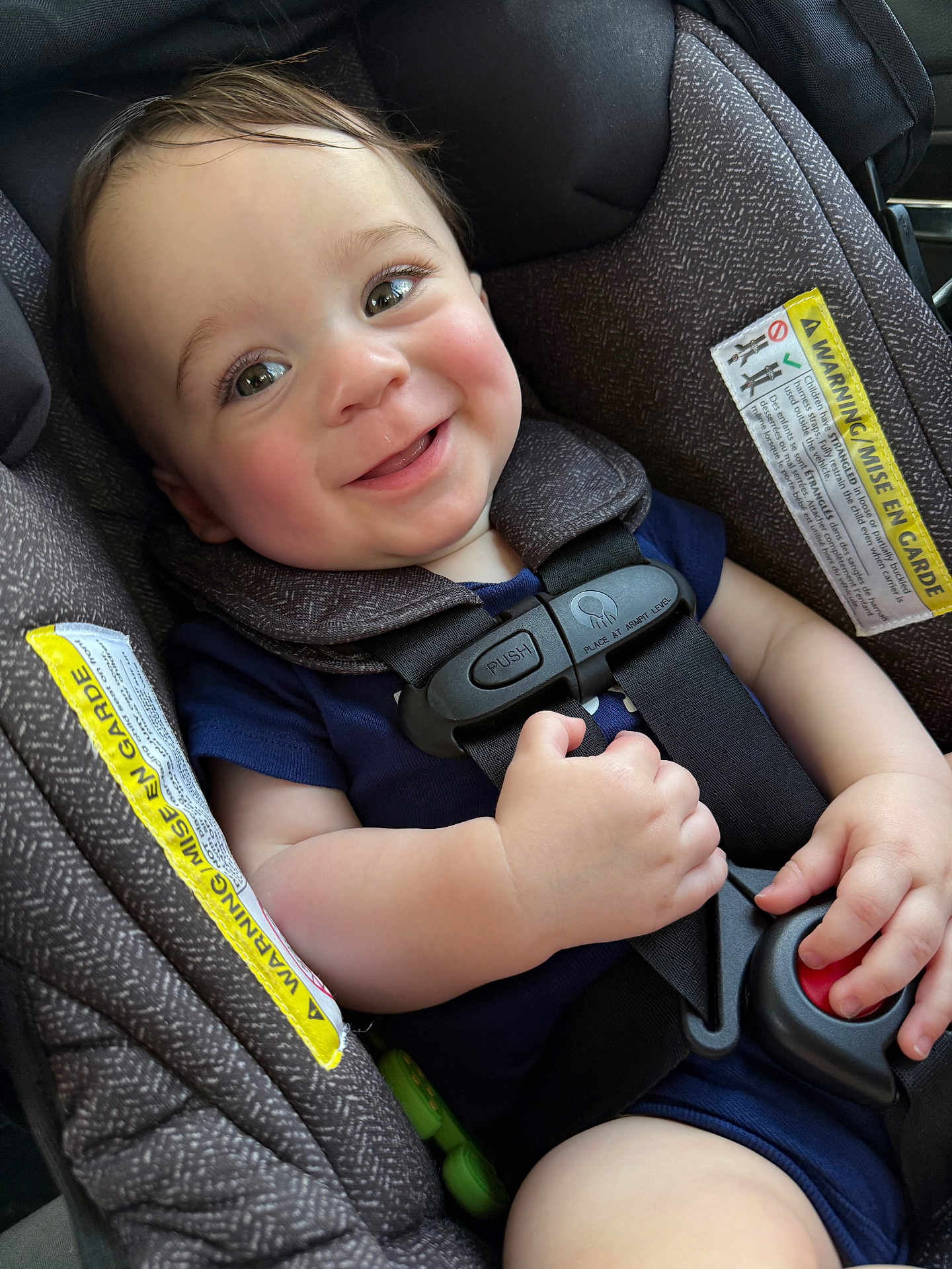 Mason is registered to the contest to win money with this photo: baby, car_seat, harness, smiling, child, infant, seatbelt, cute, face, cheeks, clothing, sitting, hand, safety, closeup, person, indoors, happy, young, transport