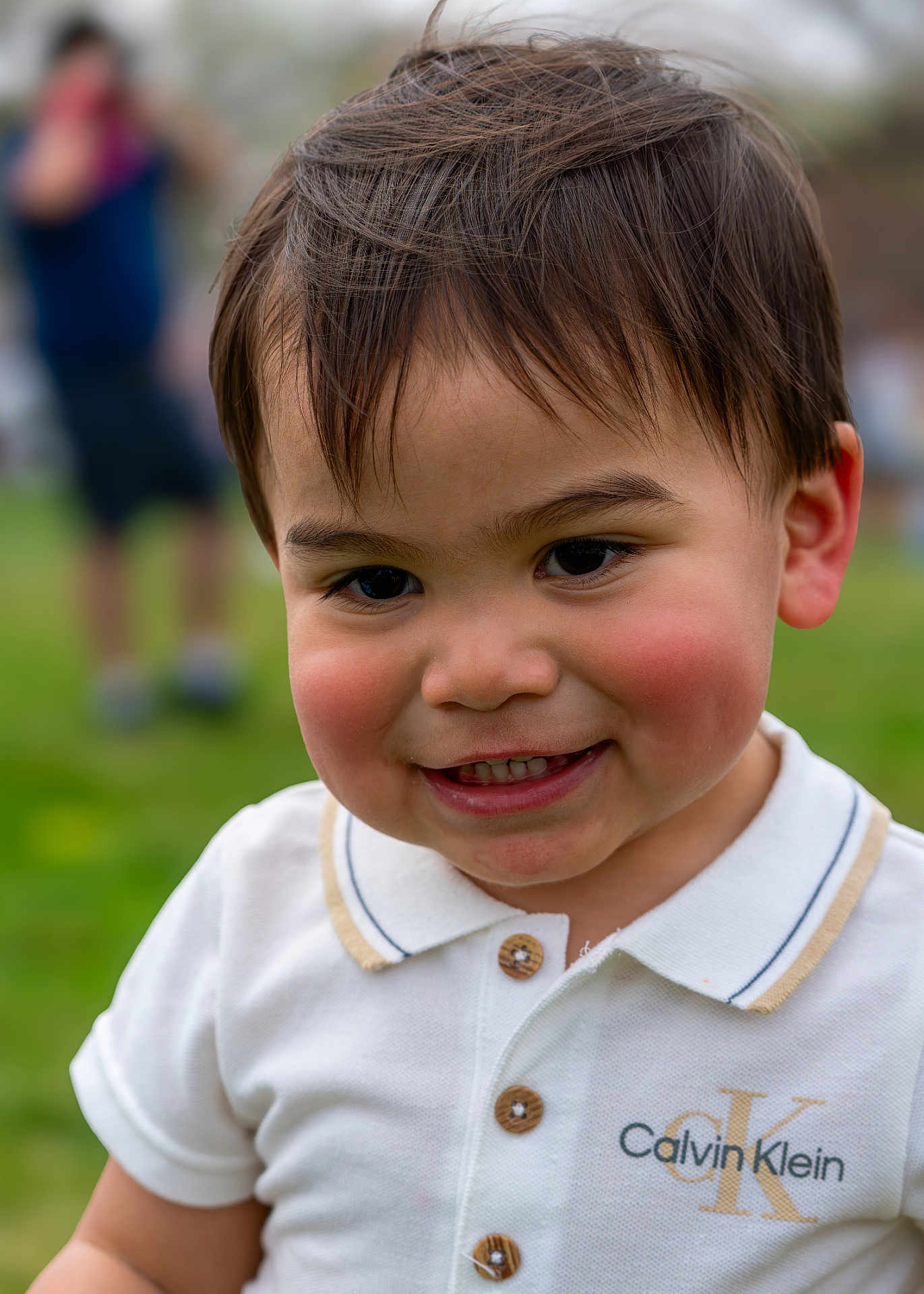 Malachi joined the competition — help win amazing prizes! toddler, child, smiling, outdoor, grass, polo_shirt, calvin_klein, fashion, face, portrait, happy, cute, young_child, buttoned_shirt, short_hair, cheeks, daylight, person, casual_clothing, blurred_background