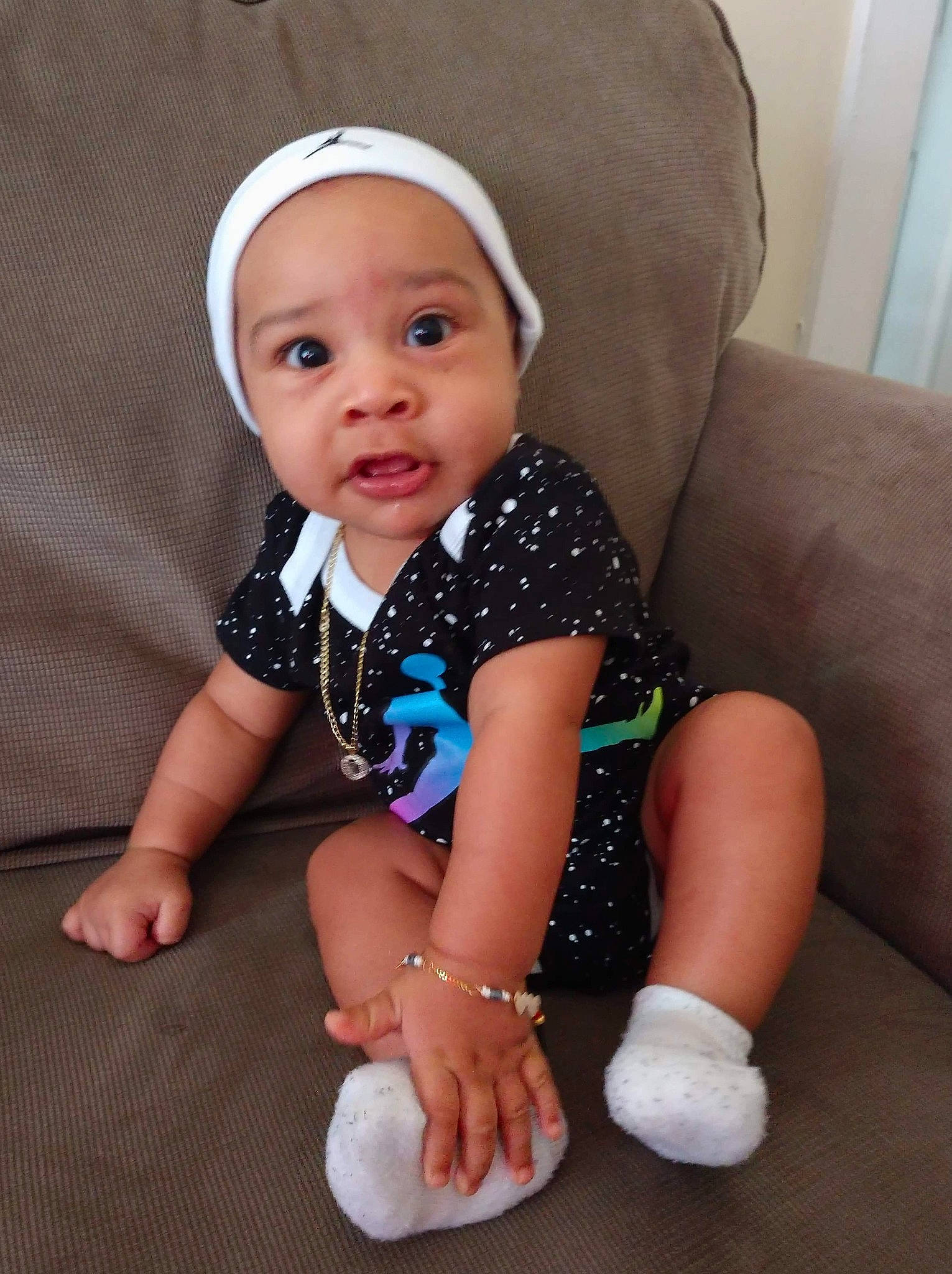 Ky is registered to the contest to win money with this photo: baby, baby_products, baby_toddler_clothing, child, fashion_accessory, headgear, headwear, leg, person, play, product, sitting, skin, toddler