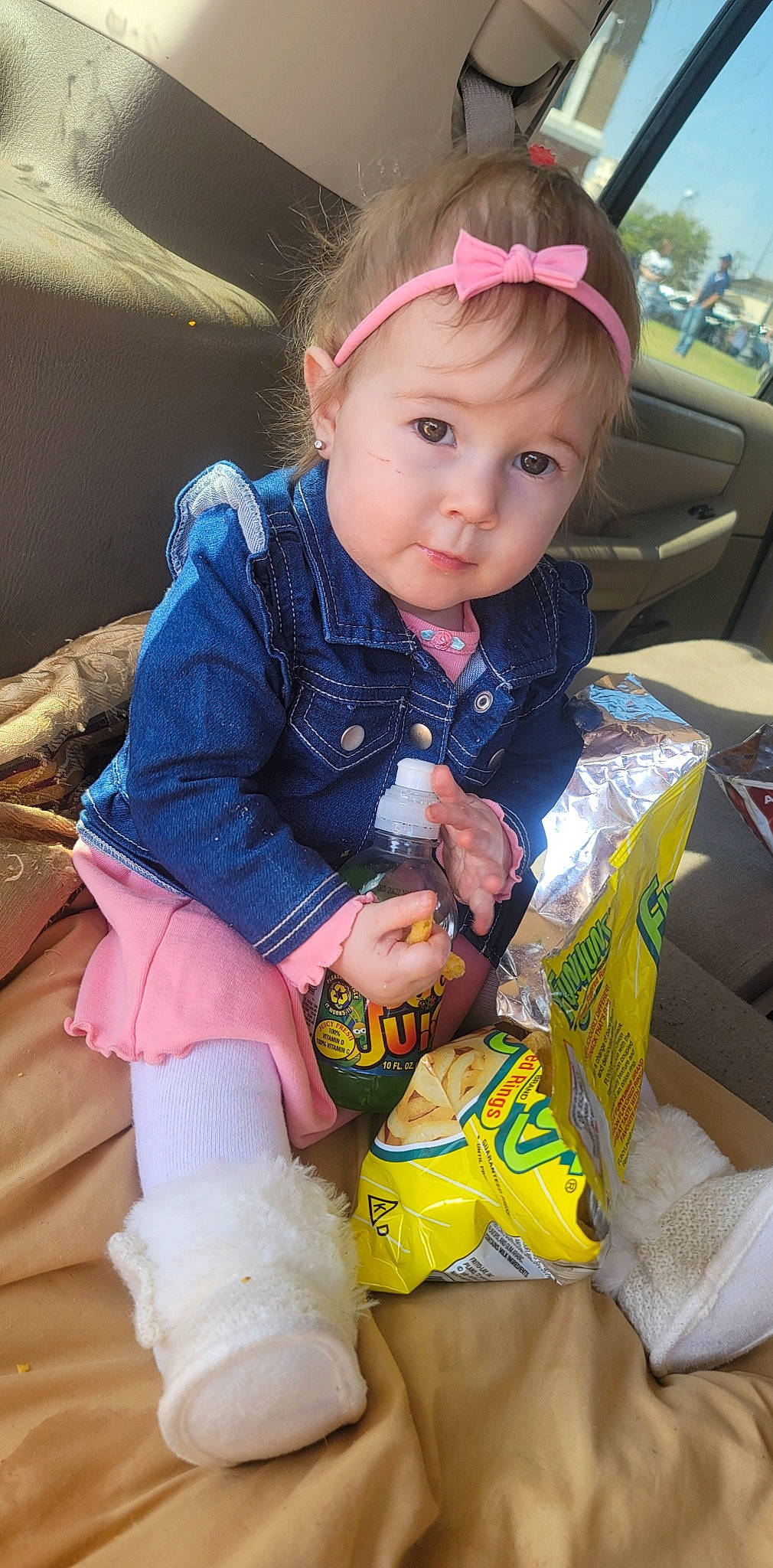 Freya is registered to the contest to win money with this photo: baby, baby_toddler_clothing, car_seat, child, face, fun, happy, head, human_leg, knee, lap, pattern, person, pink, sitting, skin, sleeve, sock, thigh, toddler