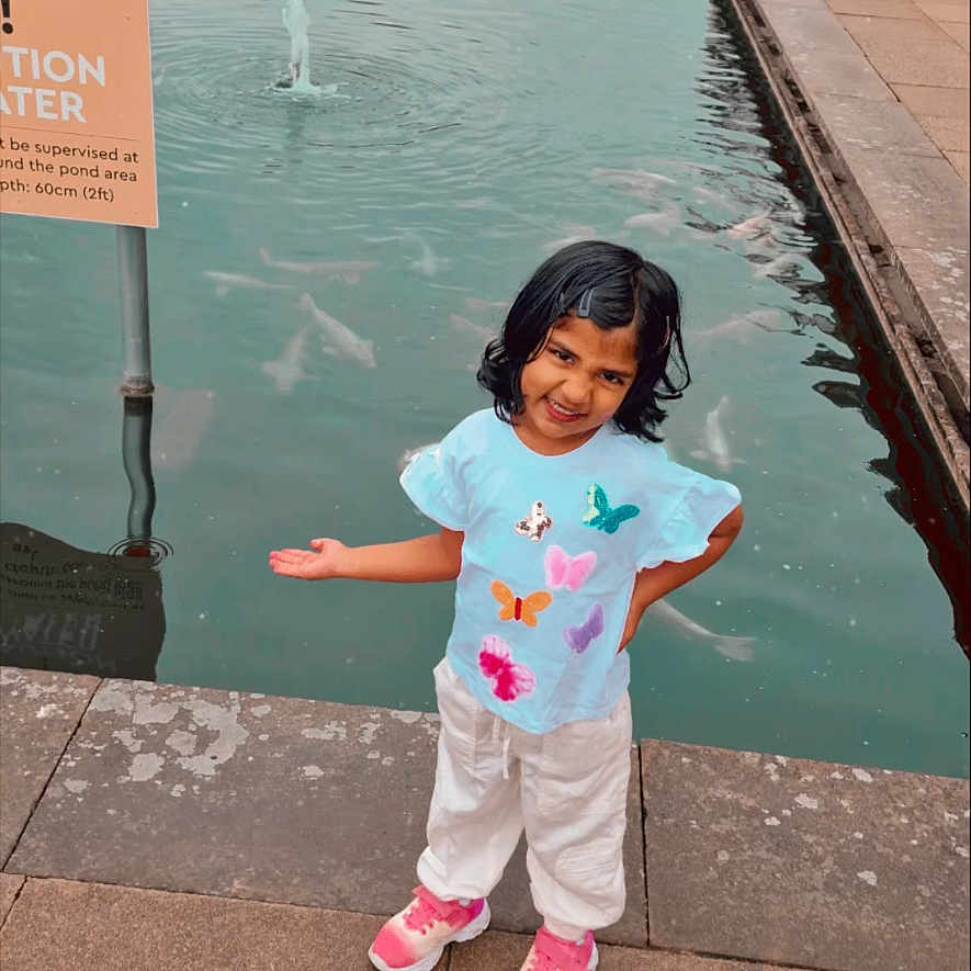 Maanvi is registered to the contest to win money with this photo: advertisement, bodypart, child, clothing, coat, face, female, finger, girl, hand, head, pants, path, person, photography, pool, portrait, poster, t_shirt, water