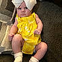 Kaylee joined the competition — help win amazing prizes! baby, infant, yellow_dress, white_bow, socks, couch, upholstery, fabric, child, portrait, indoors, seated, cute, expression, small_hands, legs, feet, clothing, pattern, texture