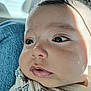 baby, close_up, face, child, infant, skin, cheeks, eyes, person, clothing, lap, denim, curious, expression, natural_light, shadow, portrait, indoors, head, young