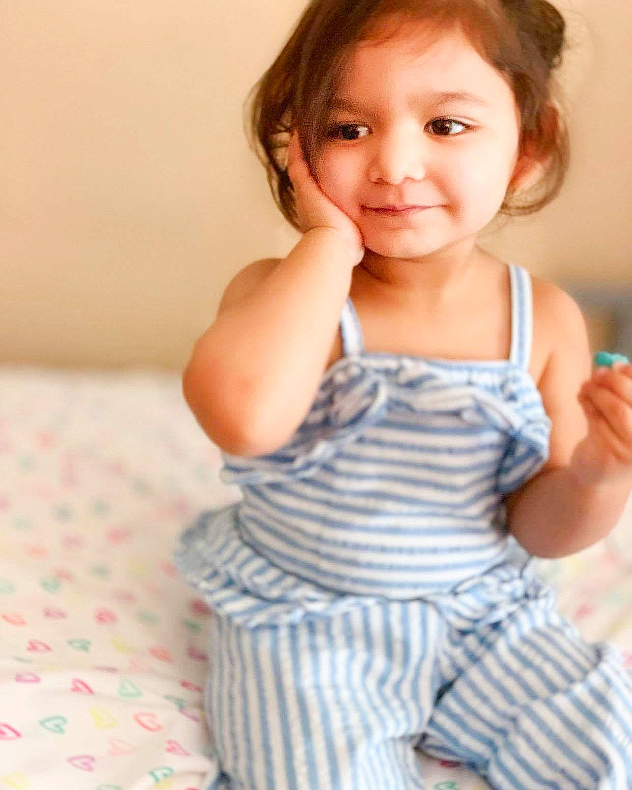 Joy is registered to the contest to win money with this photo: baby, baby_toddler_clothing, beauty, cheek, child, child_model, finger, gesture, joy, person, sitting, skin, smile, toddler