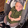 baby, sleeping, stroller, headband, green_dress, pacifier, polka_dot_tights, fuzzy_slippers, infant, child, indoor, seat, warning_label, hands, face, cute, peaceful, soft_lighting, wooden_floor, cozy
