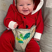 Hazlee joined the competition — help win amazing prizes! baby, smiling, red_clothing, hooded_onesie, baby_seat, turtle_design, infant, happy, cute, child, footwear_free, patterned_cushion, indoor, baby_boy, comfort, toothy_grin, close_up, seated, infant_clothing, baby_fashion