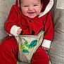baby, smiling, red_clothing, hooded_onesie, baby_seat, turtle_design, infant, happy, cute, child, footwear_free, patterned_cushion, indoor, baby_boy, comfort, toothy_grin, close_up, seated, infant_clothing, baby_fashion