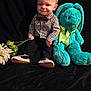 baby, child, plush_toy, stuffed_animal, bunny, flower, bouquet, clothing, bow_tie, checkered_shirt, black_pants, sneakers, indoor, portrait, smile, cute, toy, black_background, seated, infant