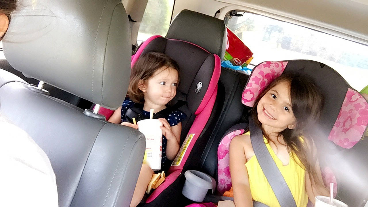 Payton is registered to the contest to win money with this photo: auto_part, car, car_seat, car_seat_cover, child, family_car, head_restraint, joy, person, pink, seat_belt, vehicle