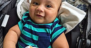 Ivan joined the competition — help win amazing prizes! baby, child, stroller, blanket, striped_shirt, smile, face, arm, clothing, fabric, pattern, comfort, cute, infant, portrait, outdoor, hand, seat, head, expression