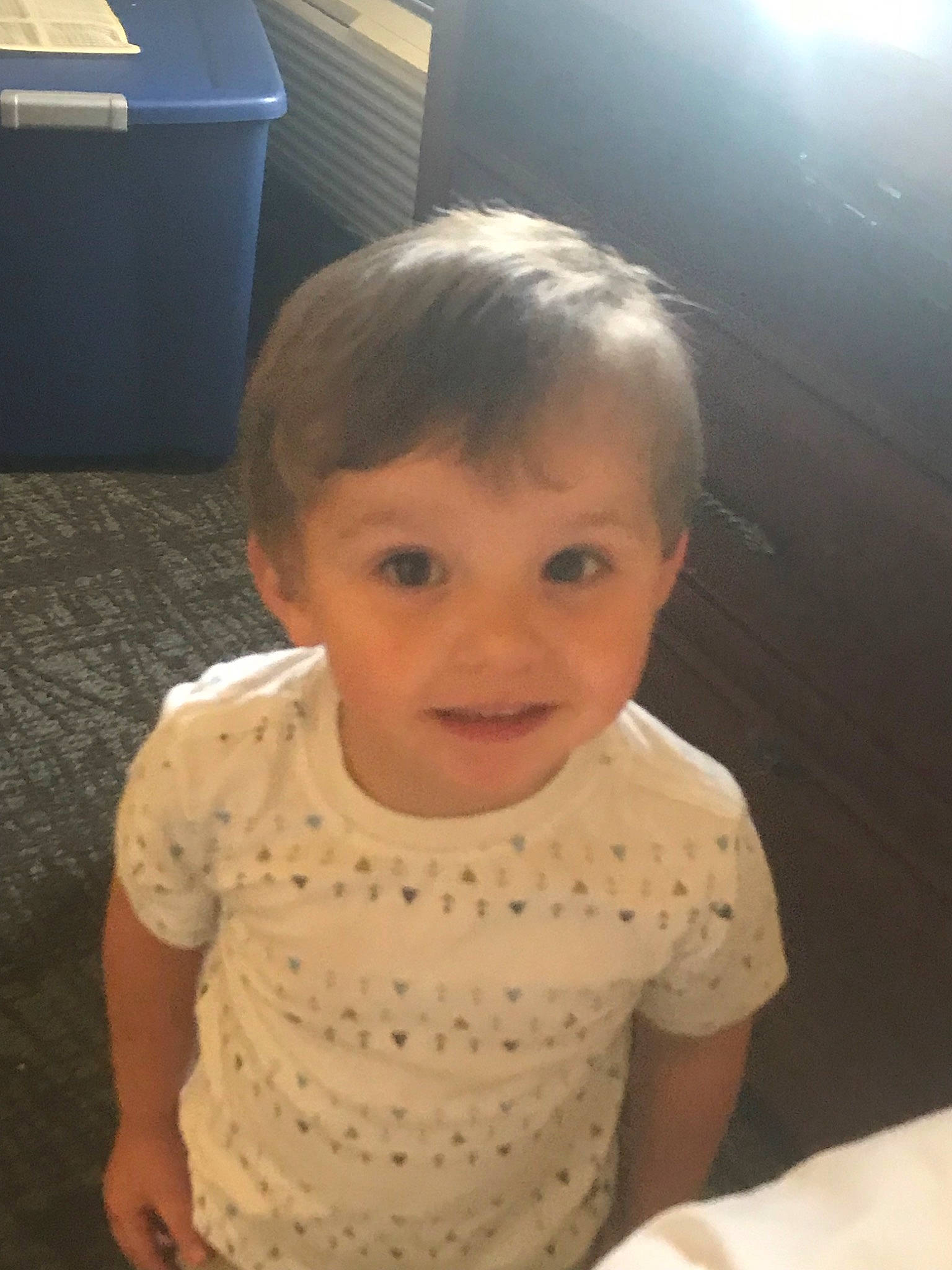 Brentley is registered to the contest to win money with this photo: arm, baby, cheek, child, chin, eye, face, forehead, hair, hairstyle, head, iris, mobile_phone, nose, person, sitting, skin, smile, standing, technology