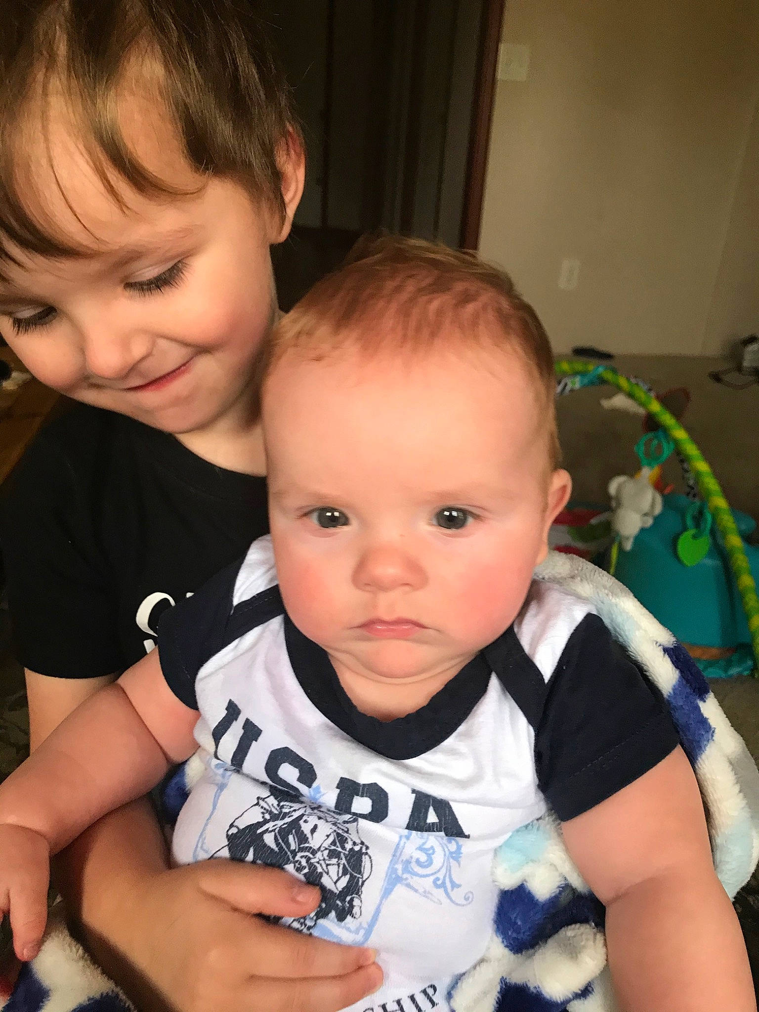 Brentley is registered to the contest to win money with this photo: baby, cheek, child, ear, eye, face, forehead, head, iris, joy, nose, person, photography, play, sibling, skin, smile, t_shirt, toddler