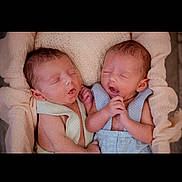 Ransom N Branson is registered to the contest to win money with this photo: newborn, twins, baby, sleeping, infant, cute, soft_fabric, pastel_colors, cozy, close_up, portrait, peaceful, tiny_hands, newborn_clothing, indoor, family, adorable, skin, resting, infancy