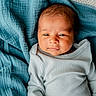 baby, blanket, blue_blanket, child, clothing, cozy, cute, eyes, face, head, indoor, infant, lying_down, newborn, person, portrait, skin, sleepy, soft_texture, white_onesie