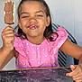 child, girl, ice_cream, chocolate, pink_dress, smile, happy, food, summer, sweet, dessert, face, hand, table, sitting, indoor, portrait, cute, messy, fun