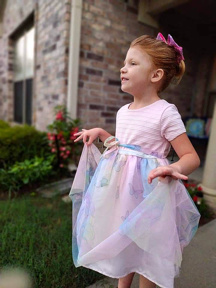 Harleigh is registered to the contest to win money with this photo: baby_toddler_clothing, day_dress, dress, event, face, fashion_design, formal_wear, fun, gown, grass, happy, magenta, one_piece_garment, person, plant, skin, sleeve, street_fashion, summer, toddler