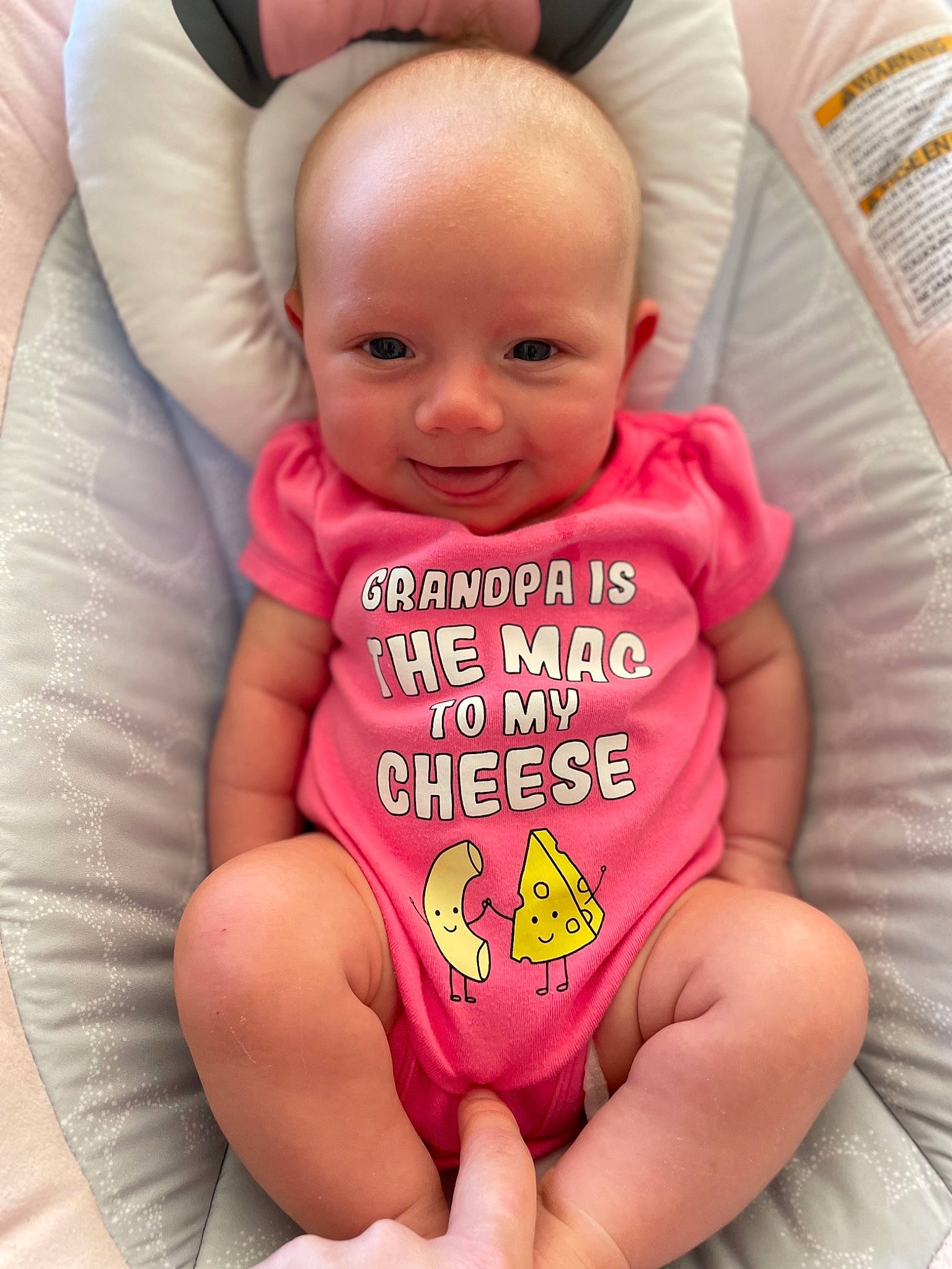 Vivian is registered to the contest to win money with this photo: baby, baby_toddler_clothing, cheek, comfort, eye, finger, hand, happy, head, human_body, mouth, neck, organ, person, pink, skin, sleeve, smile, textile, thigh