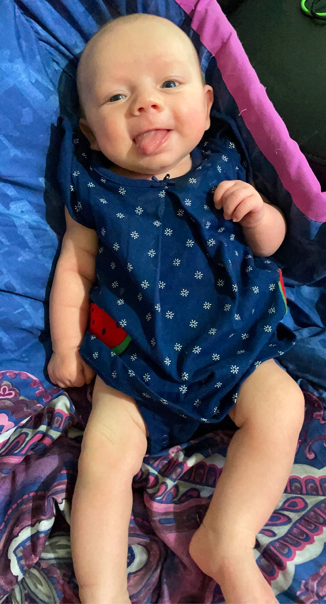 Vivian is registered to the contest to win money with this photo: baby, baby_toddler_clothing, blue, cheek, electric_blue, face, finger, fun, gesture, happy, head, neck, pattern, person, pink, skin, sleeve, smile, thigh, thumb