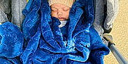 Usayd Al Malik joined the competition — help win amazing prizes! baby, blanket, blue_blanket, beige_hat, stroller, sleeping, infant, cozy, outdoor, sunlight, warm, child, cute, knit_hat, resting, person, car_seat, soft_texture, peaceful, toddler