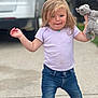 toddler, child, toy, stuffed_animal, outdoor, driveway, jeans, shirt, white_shoes, blond_hair, blue_eyes, casual_clothing, playful, expression, standing, daylight, residential, car, person, cute
