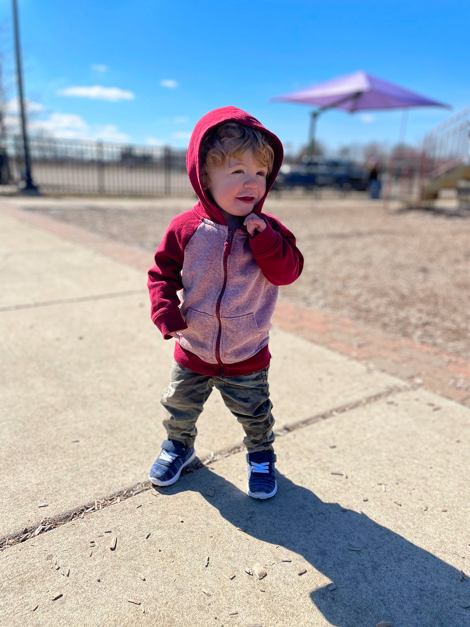 Dixon is registered to the contest to win money with this photo: asphalt, baby, baby_toddler_clothing, cloud, electric_blue, fun, grass, happy, hat, headgear, landscape, leisure, magenta, person, personal_protective_equipment, sand, sky, tints_and_shades, toddler, travel