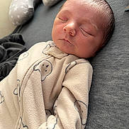 Elliot is registered to the contest to win money with this photo: baby, newborn, infant, sleeping, onesie, blanket, pillow, bed, cozy, soft, face, cheeks, closed_eyes, peaceful, portrait, cute, skin, head, fabric, laying_down