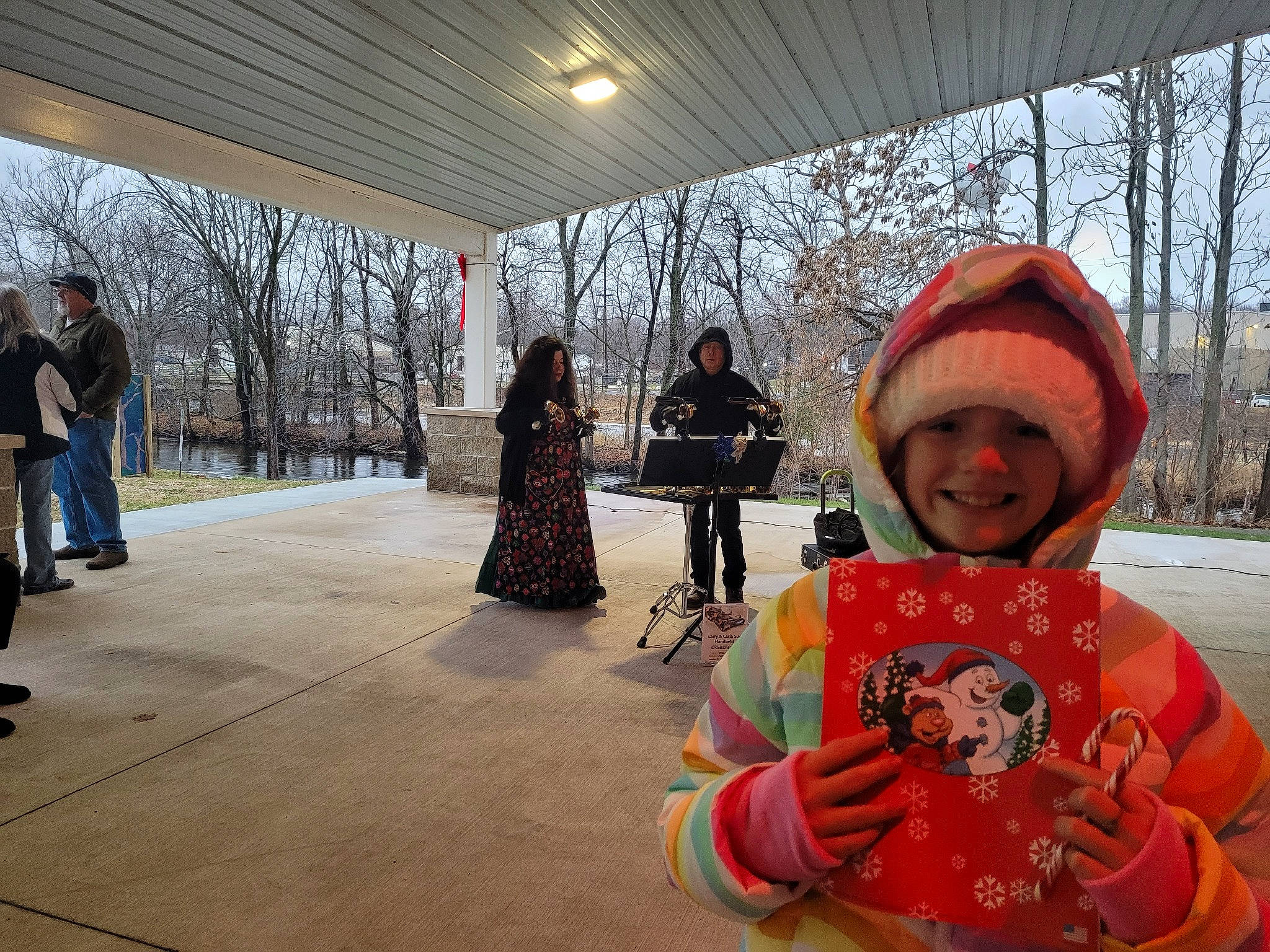 Aubrey is registered to the contest to win money with this photo: backpack, bag, cap, child, event, freezing, fun, headwear, jacket, joy, leisure, luggage_and_bags, person, public_space, recreation, sky, smile, snow, toddler, travel