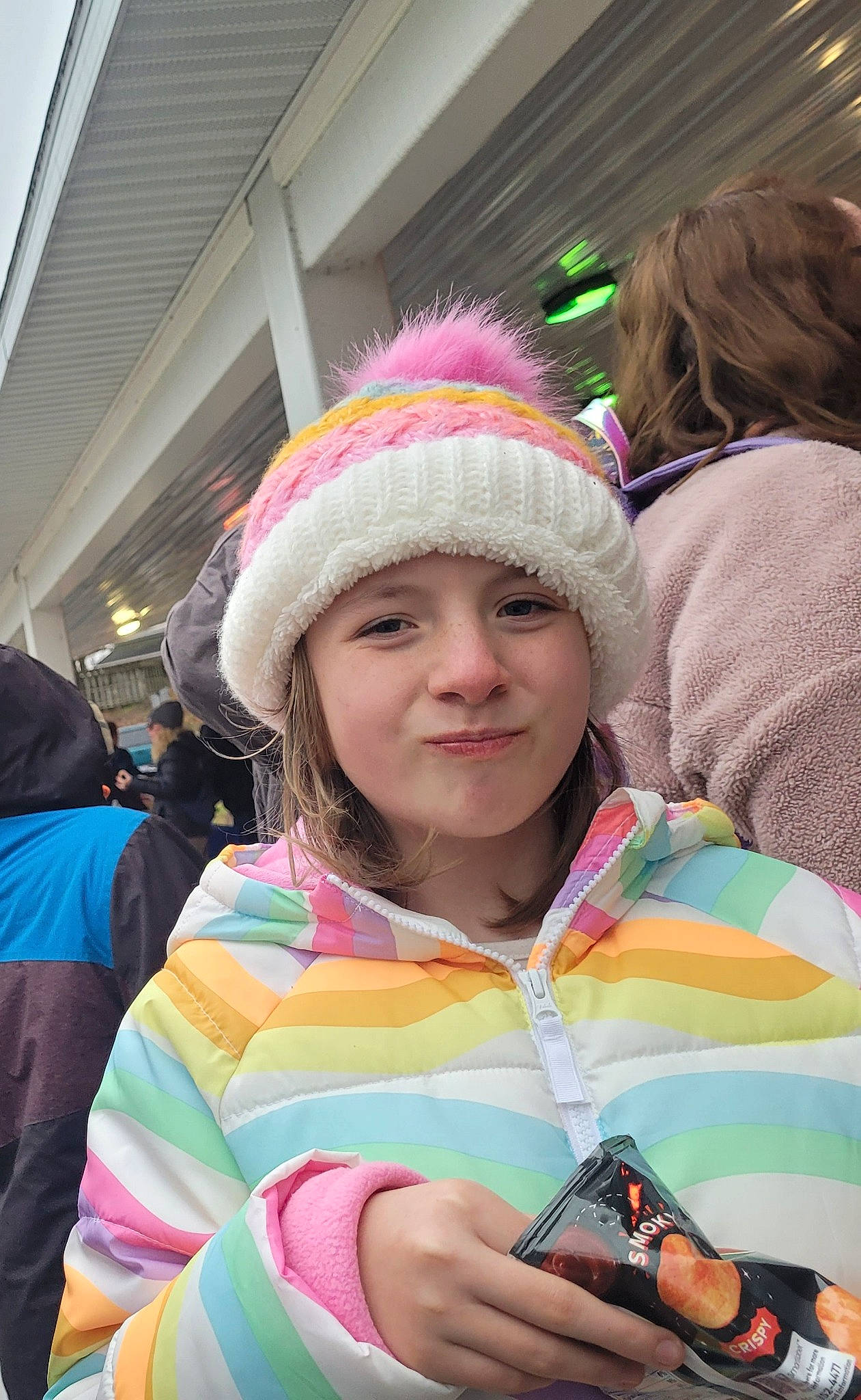 Aubrey is registered to the contest to win money with this photo: cap, child, crowd, event, eyewear, fun, happy, headgear, headwear, jacket, joy, knit_cap, leisure, magenta, mobile_phone, people, person, pink, public_event, recreation