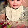 baby, background, berries, bib, blond_hair, child, clothing, cute, face, food, happy, high_chair, indoor, infant, person, portrait, sitting, smiling, table, young_child