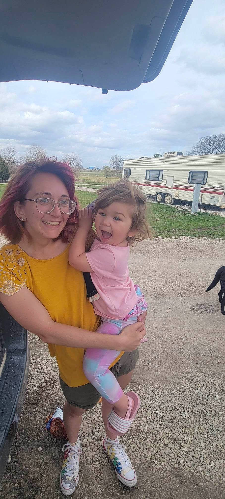 Thelma is registered to the contest to win money with this photo: aircraft, airplane, cloud, event, fun, gesture, glasses, grass, happy, joy, leg, leisure, person, plant, recreation, skin, sky, smile, thumb, toddler