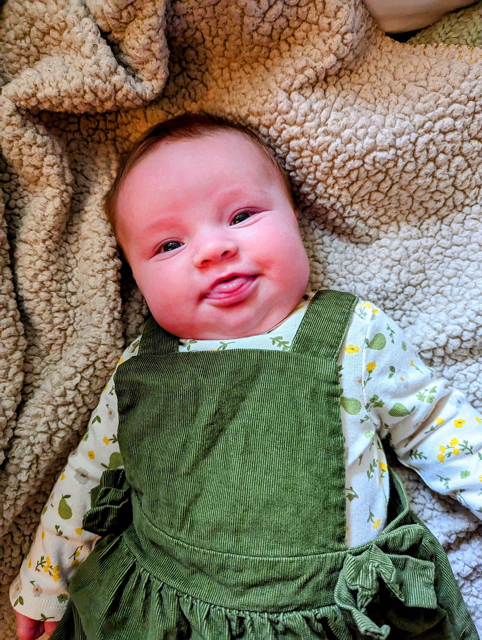 Aurelia is registered to the contest to win money with this photo: baby, baby_toddler_clothing, cheek, child, comfort, face, grass, happy, linens, outerwear, pattern, person, sitting, skin, sleeve, smile, textile, toddler, wood, wool