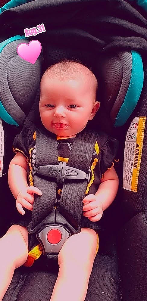 Amara is registered to the contest to win money with this photo: baby, baby_carriage, baby_safety, baby_toddler_clothing, cheek, comfort, cool, facial_expression, finger, happy, head, human_body, mammal, person, pink, product, purple, skin, sleeve, smile