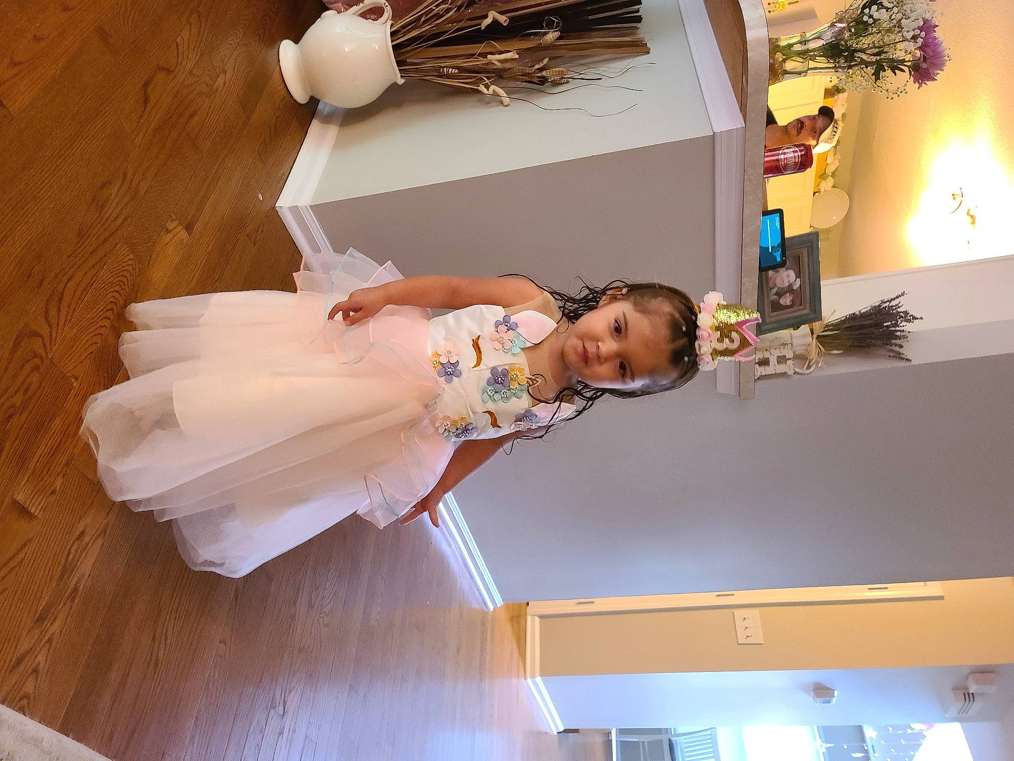 Sadie joined the competition — help win amazing prizes! bridal_clothing, ceiling, child, dress, elbow, event, fashion_design, flooring, fun, happy, hardwood, headwear, mechanical_fan, person, room, toddler, toy, wedding_dress, wood, wood_flooring