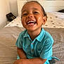 toddler, child, smiling, happy, indoor, bed, bedroom, clothing, turquoise, person, sitting, crossed_legs, cute, young_child, portrait, skin, face, hair, button_up_shirt, casual