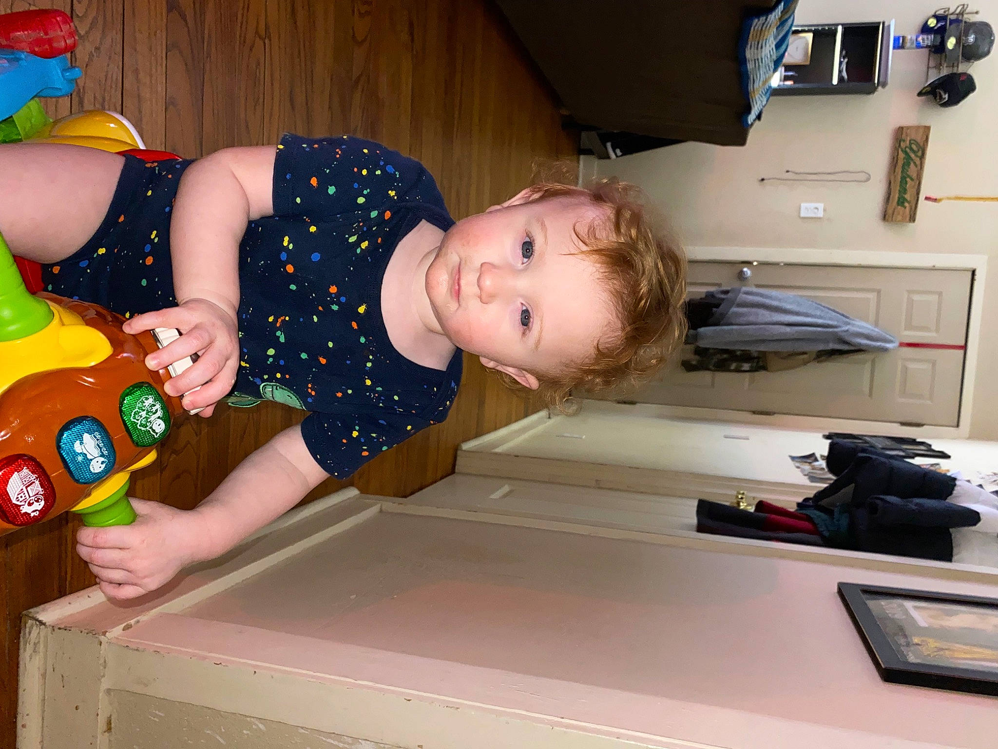 Aydan is registered to the contest to win money with this photo: baby, baby_products, baby_toddler_clothing, child, fun, happy, home_appliance, person, room, sitting, t_shirt, toddler, toy