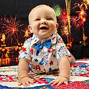 Weston joined the competition — help win amazing prizes! baby, background, bow_tie, celebration, child, colorful, crawling, cute, face, festive, fireworks, hands, happy, indoor, night, pattern, portrait, quilt, shirt, smiling