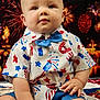 Weston is registered to the contest to win money with this photo: baby, background, blue_bow_tie, celebration, child, clothing, colorful, cute, eyes, face, fireworks, hands, holiday, indoor, patriotic, portrait, shirt, shorts, sitting, stars