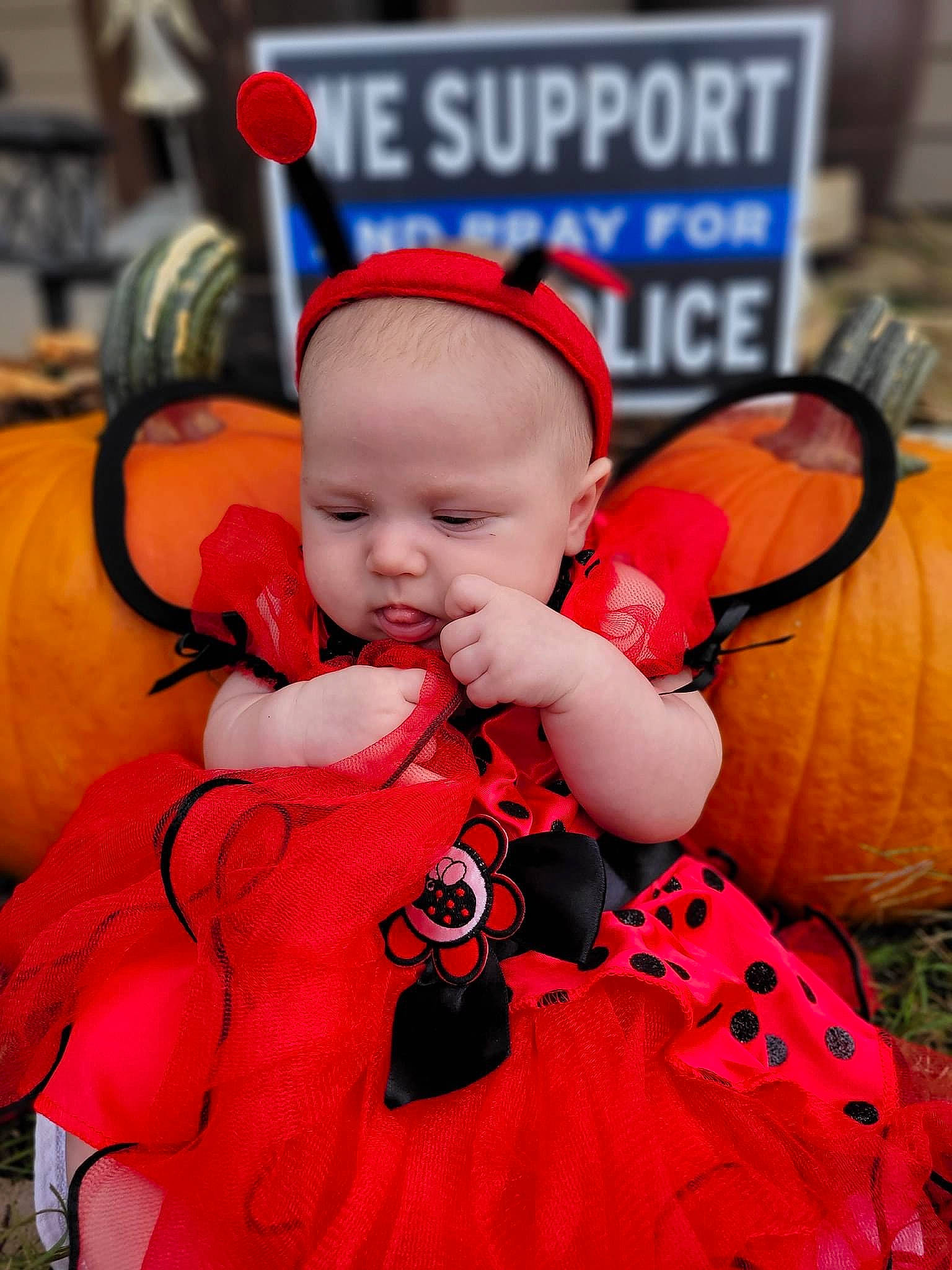 Ella-mae is registered to the contest to win money with this photo: baby, baby_products, baby_toddler_clothing, baseball_cap, cap, child, costume, costume_hat, event, fun, happy, headgear, logo, orange, peach, person, personal_protective_equipment, pink, recreation, red